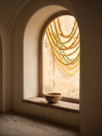Mehendi Hands — Warm courtyard daylight, marigold soft behind.